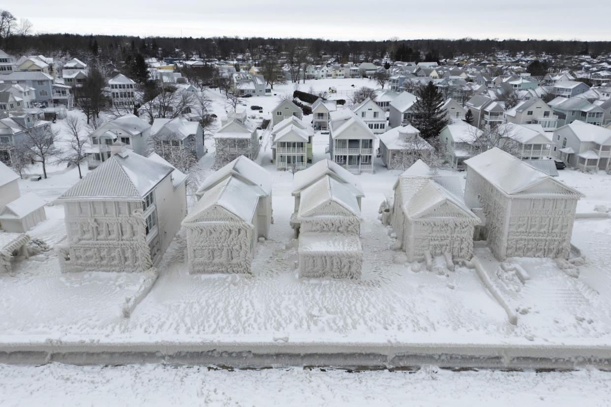 An aerial image taken by drone of the frozen-over houses and their frozen back lawns.