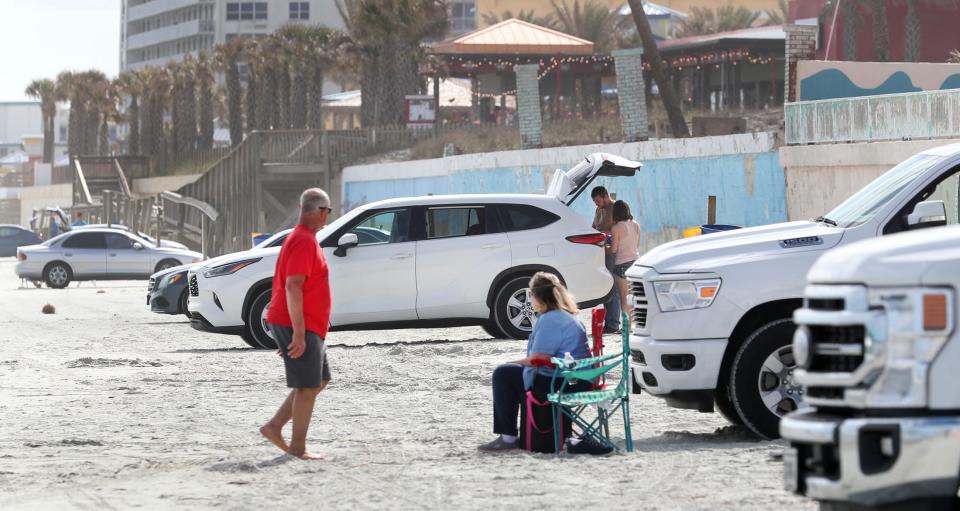 Beachgoers enjoy some time on the sand, Tuesday, Jan. 24, 2023, just south of the International Speedway Boulevard beach ramp.