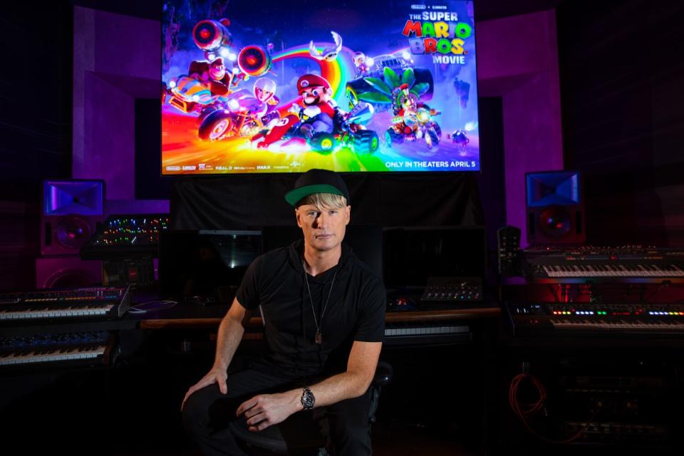 Brian Tyler in front of a mixing board.