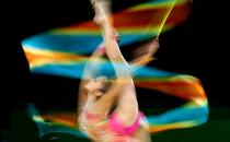 <p>Malaysia’s Izzah Amzan competes in the ribbon discipline in the rhythmic gymnastics at the Commonwealth Games. She claimed a silver medal in the team event (Martin Rickett/PA). </p>