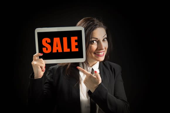 Word sale on tablet with woman holding it