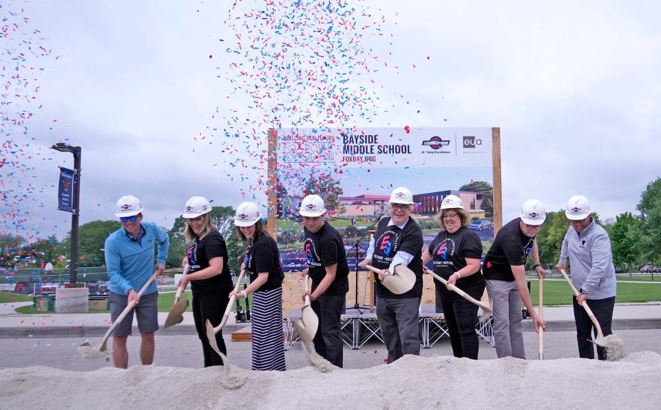 Confetti shoots off as district leaders take part in a groundbreaking ceremony for construction of the new Bayside Middle School in July. They are, from left, Marc Grasswick, director of facility services; Amanda Orth, director of technology; Laura Dahm, director of teaching and learning; Joseph Stiglitz, Bayside associate principal; Jeff Dellutri, superintendent; Kathleen Wiesner, director of business services; Paul Reich, director of student services; and Jodi Hackl, Bayside principal. The new school, which is being built next to the current school on East Ellsworth Lane, was funded through a $58.5 million referendum that passed in April 2022. The funds will also provide upgrades to Stormonth Elementary School in Fox Point.