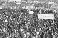 File - Tens of thousands of Iranian women gather in northern Tehran in 1979 at a counter-demonstration called to support Ayatollah Khomeini's desire for women to wear the traditional "chador" and to adhere fully to Islamic laws. Iran's Islamic Republic requires women to cover up in public. But many Iranian women have long played a game of cat-and-mouse with authorities as a younger generation wears their veils more loosely or skirts requirements for conservative dress. (AP Photo/Randy Taylor, File)