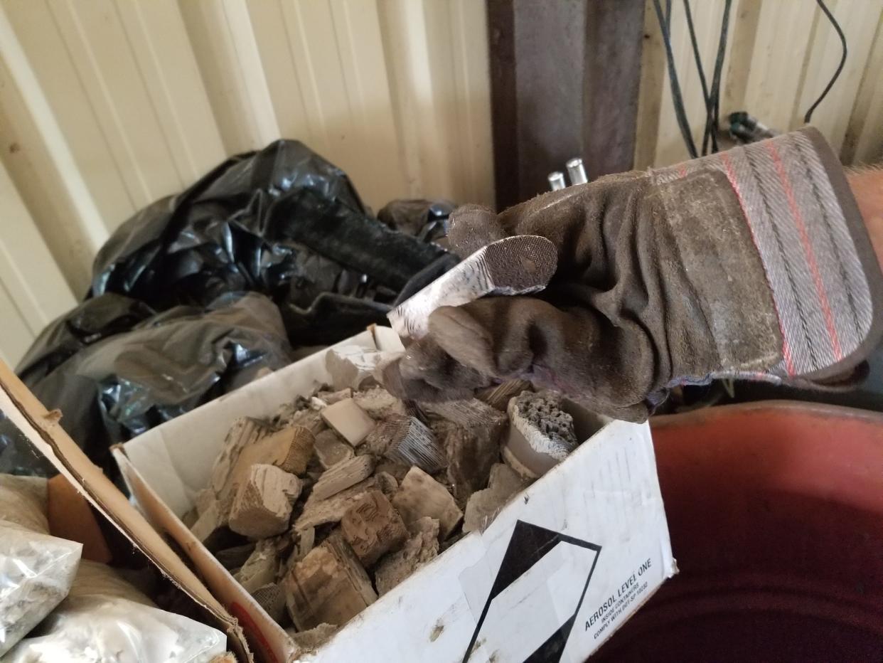 These ceramic coated pieces are found inside catalytic converters. They contain valuable precious metals, according to a scrap yard worker.