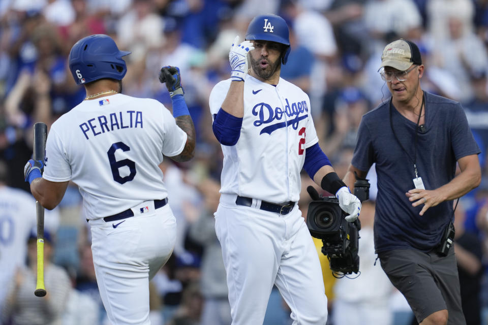 Los Angeles Dodgers designated hitter J.D. Martinez (28) celebrates with David Peralta (6) after hitting a home run during the seventh inning of a baseball game against the New York Yankees in Los Angeles, Sunday, June 4, 2023. (AP Photo/Ashley Landis)