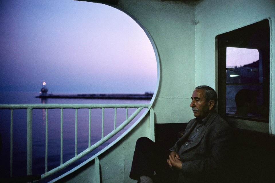 <p>On board a ferry at dusk near the Princess Islands, Istanbul, Turkey, 2001. “Over the course of seven years — from 1998 to 2005 —I wandered the streets of Istanbul, from Cihangir to Ayvansaray, from Üsküdar to Altin ehir, from Kadiköy to the ancient Theodosian walls. Meandering its warren of winding streets and riding its ferries, I found that serendipity guided me — in its roundabout way. More often than not, I had to lose my way in order to find my most successful photographs. In 2001, I remember crossing the Sea of Marmara after a frustrating series of missed ferries and lost opportunities — a typical afternoon for a street photographer. In the fading light, I thought I was done for the day, and was considering ordering a tea to help fend off the brisk sea air. Then something caught my eye: an older Turkish man, lost in thought, framed by the pink-purple glow of dusk. His reverie had a kind of mysterious weight to it — hard-to-define, yet almost palpable. In that moment, I slowly began to understand — at least visually — Orhan Pamuk’s notion of ‘hüzün,’ an untranslatable word that suggests a rich and complicated melancholy that’s unique to Istanbul, the writer’s birthplace and one of the most astonishingly beautiful cities in the world, a place that seems haunted by its past, and, these days, beleaguered by its present.” (© Alex Webb/Magnum Photos) </p>