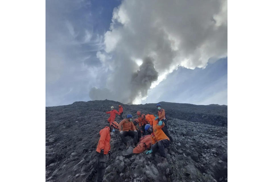 UPDATES THE DATE OF THE PHOTO TAKEN - In this photo released by the Indonesian National Search and Rescue Agency (BASARNAS), rescuers prepare to evacuate the body of a climber killed in Mount Marapi's eruption in Agam, West Sumatra, Indonesia, on Tuesday, Dec. 5, 2023. Rescuers searching the hazardous slopes of Indonesia's Marapi volcano found more bodies among the climbers caught by a surprise eruption two days ago. (BASARNAS via AP)