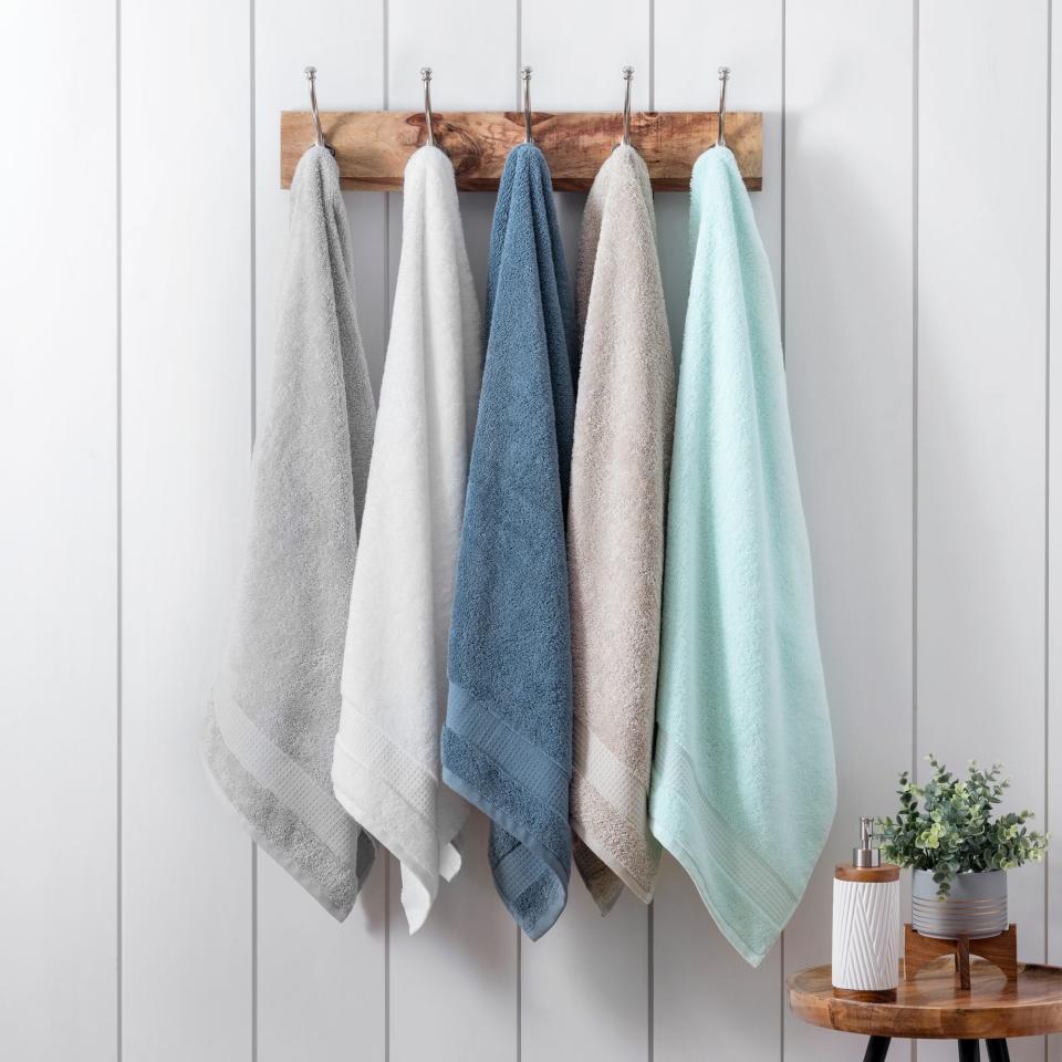 Martha towels hanging on rack in different calm colors