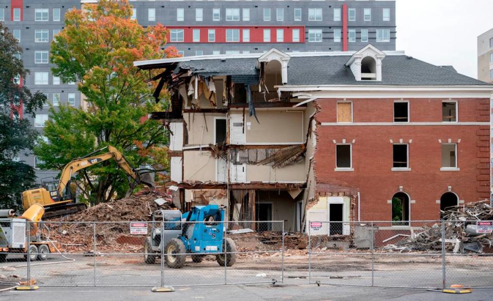 Crews work to demolish the University Club on College Avenue on Friday, Sept. 30, 2022.