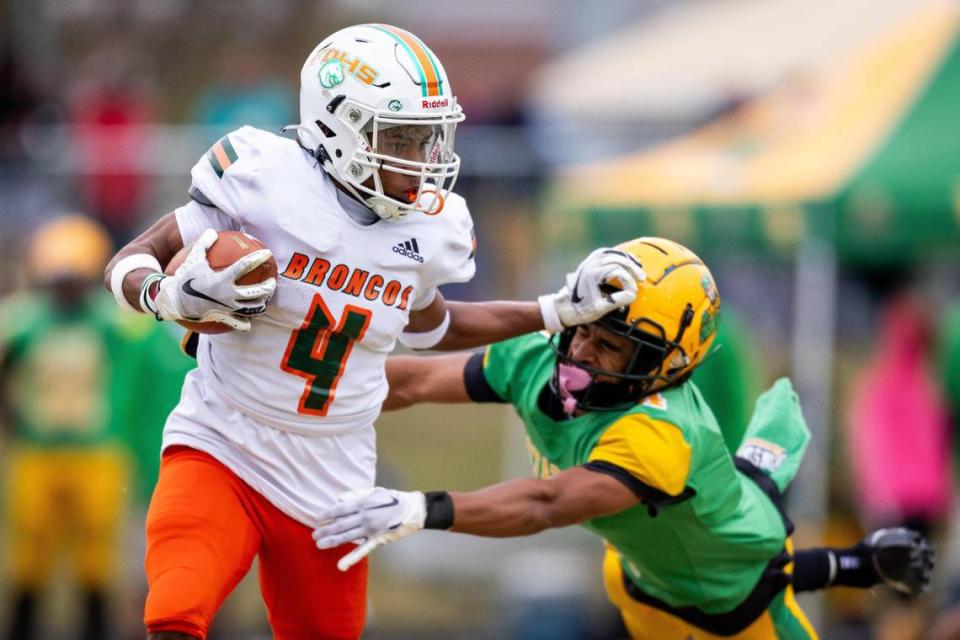 Frederick Douglass’ Derion Talbert (4) stiff arms a Bryan Station defender during their game at Bryan Station High School on Oct. 14.