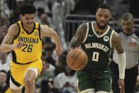 Milwaukee Bucks' Damian Lillard steals the ball from Indiana Pacers' Ben Sheppard during the first half of Game 2 of the NBA playoff basketball game Tuesday, April 23, 2024, in Milwaukee. (AP Photo/Morry Gash)