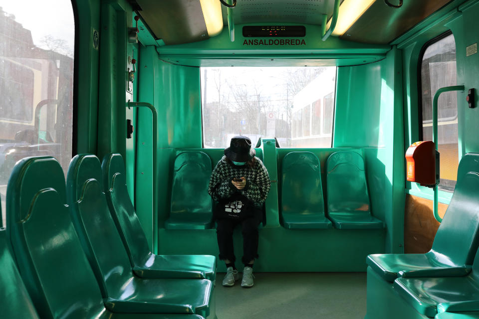 A woman wearing a protective mask is seen taking public transportation on Feb. 27 in Milan, Italy. | Marco Di Lauro—Getty Images