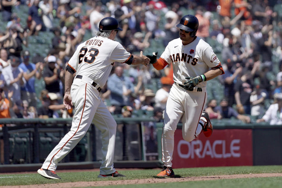 San Francisco Giants' Evan Longoria, right, is congratulated by third base coach Ron Wotus, left, as he rounds the bases after hitting a two run home run against Los Angeles Angels during the fourth inning of a baseball game Monday, May 31, 2021, in San Francisco. (AP Photo/Tony Avelar)