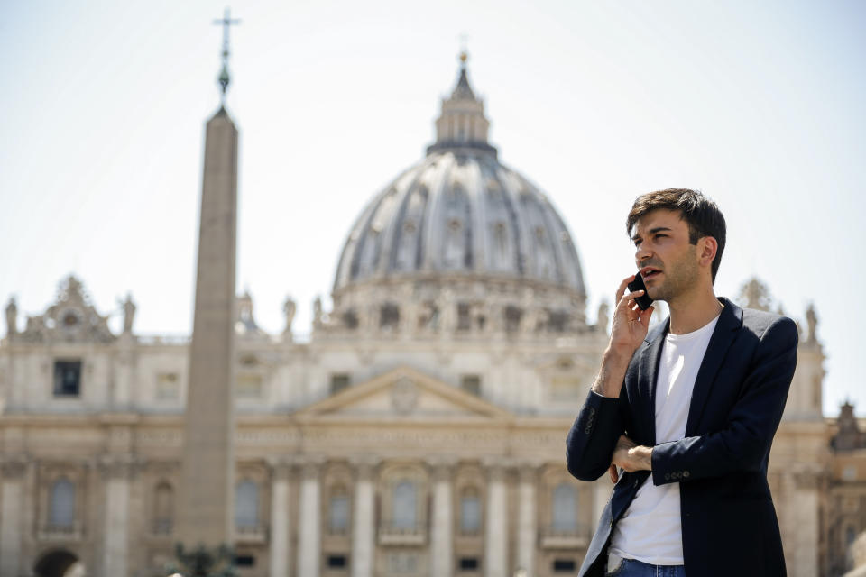Mathieu De La Souchere speaks on his cellphone after an interview with The Associated Press in St. Peter's Square at The Vatican, Wednesday, July 3, 2019. One of the half-dozen men who have accused the Vatican’s ambassador to France of groping them is taking his complaint directly to the Vatican after claiming the Holy See had invoked diplomatic immunity in a French criminal probe. Mathieu De La Souchere met with one of Pope Francis’ sex abuse advisers on Wednesday after filing a police report in Paris earlier this year. (AP Photo/Domenico Stinellis)