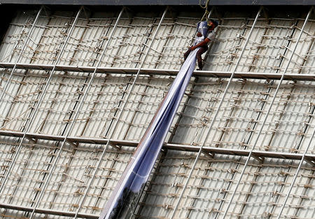 A worker installs a billboard advertising new houses in the capital Cairo, Egypt, October 3, 2018. REUTERS/Amr Abdallah Dalsh