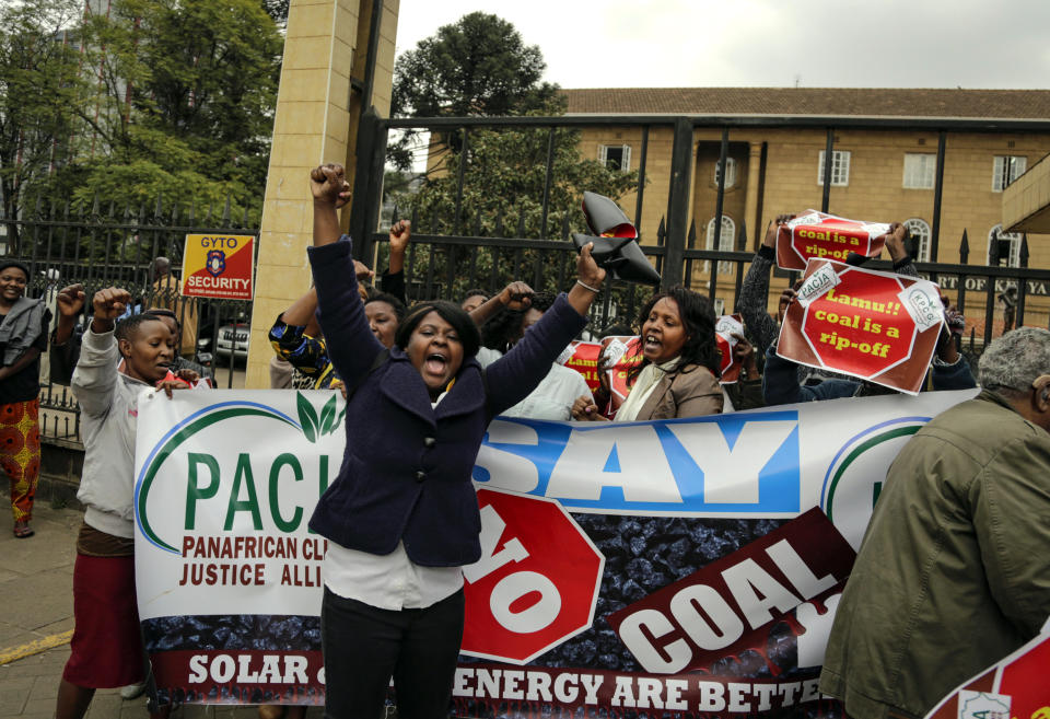 Environmental activists celebrate their victory outside the supreme court building after a tribunal ruling on the construction of a coal-fired power plant, in Nairobi, Kenya Wednesday, June 26, 2019. The Kenyan tribunal blocked the construction of the government-backed plant in Lamu County, which hosts a UNESCO world heritage site and which activists said would cause environmental damage. (AP Photo/Khalil Senosi)