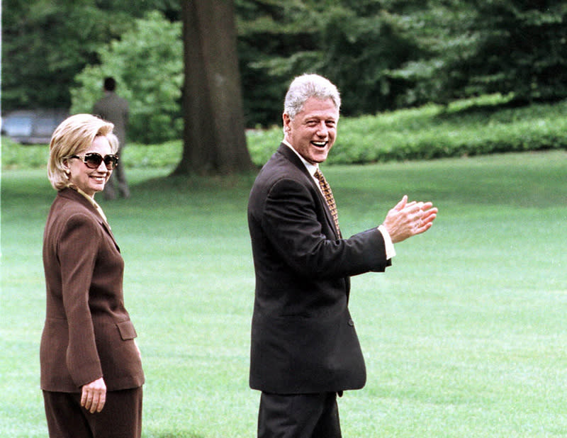 Hillary Clinton in a brown ensemble with large sunglasses on July 31, 1998