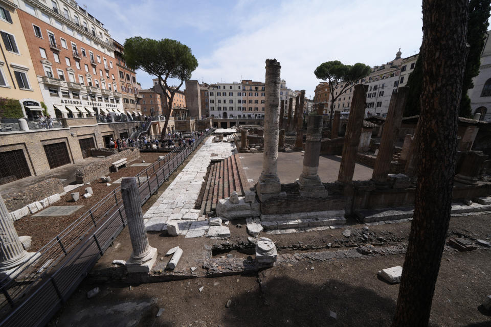 Journalists visit the new walkways of the so called 'Sacred Area' where four temples, dating back as far as the 3rd century B.C., stand smack in the middle of one of modern Rome's busiest crossroads, Monday, June 19, 2023, With the help of funding from Bulgari, the luxury jeweler, the grouping of temples can now be visited by the public that for decades had to gaze down from the bustling sidewalks rimming Largo Argentina (Argentina Square) to admire the temples below where Julius Caesar masterminded his political strategies and was later fatally stabbed in 44 B.C. (AP Photo/Domenico Stinellis)