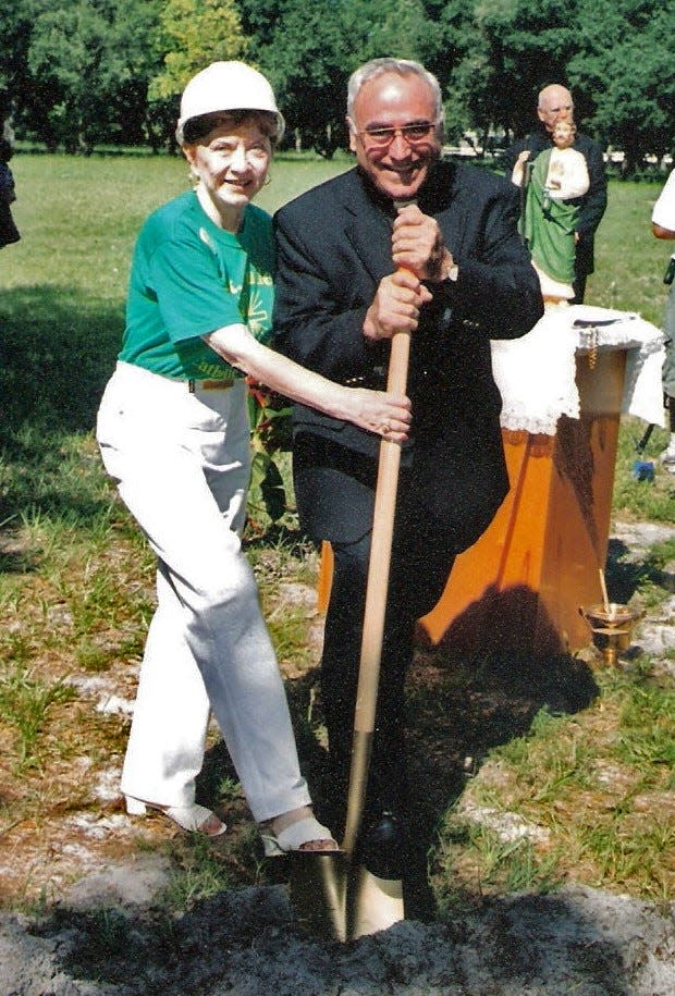 Longtime St. Jude Church parishioner Kathy Schersten and Father Celestino Gutiérrez dig in during the church's groundbreaking on June 24, 2004.