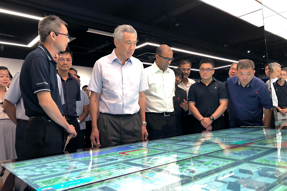 Prime Minister Lee Hsien Loong led on a guided tour of the new SG Mobility Gallery at the Land Transport Authority headquarters on Wednesday, 19 September 2018. To his left, Senior Minister of State for Transport Janil Puthucheary looks on. PHOTO: Nicholas Yong/Yahoo News Singapore