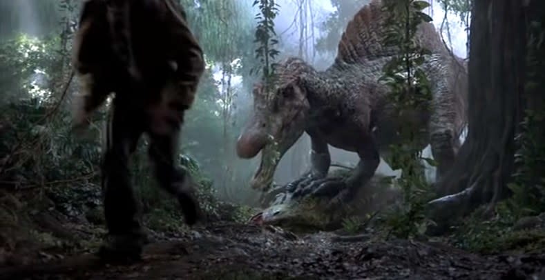 Spinosaurus stands over a T-Rex body