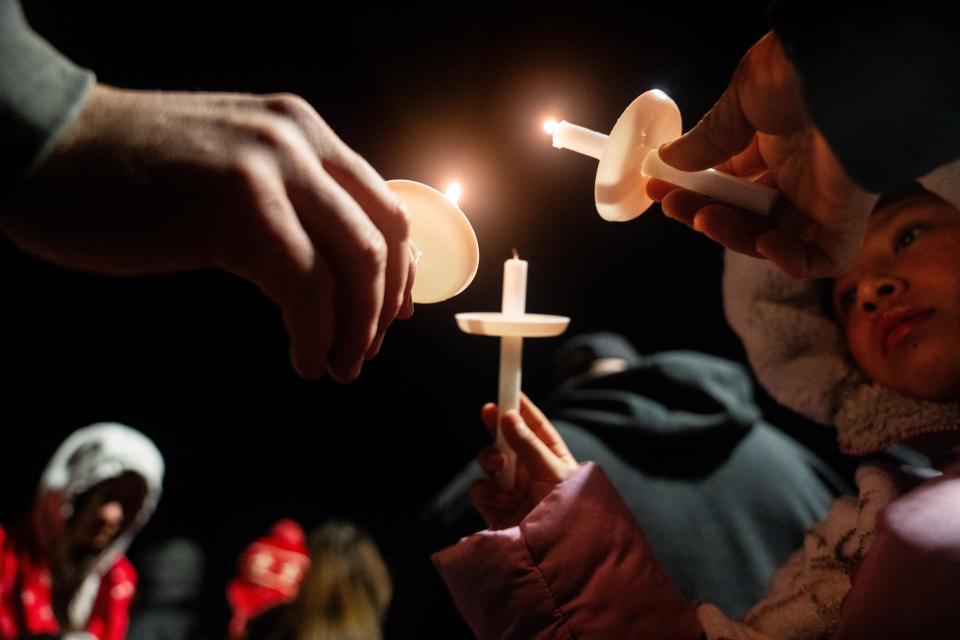 Community members gather as they honor the victims of a shooting at Perry High School Thursday, Jan. 4, 2024, at Wiese Park in Perry.