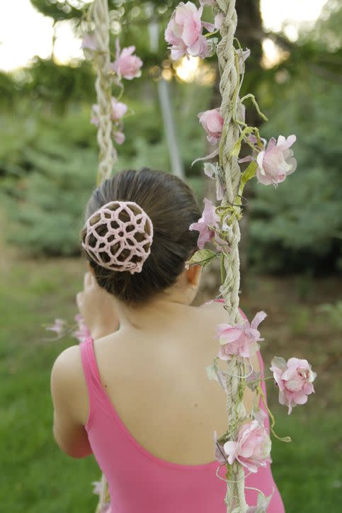 dancer with a bun in a pretty garden