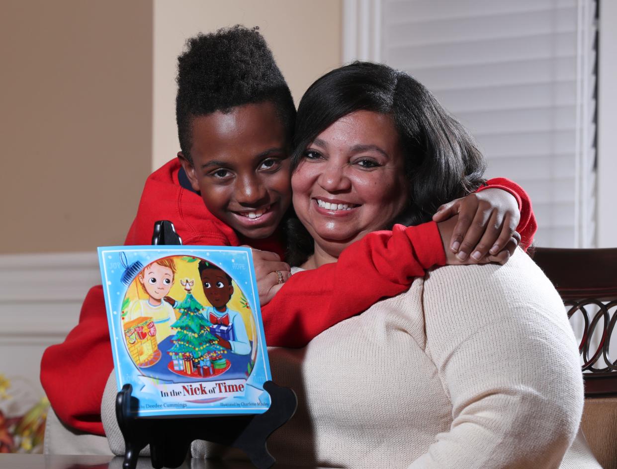 Deedee Cummings, right, with her son Nick Cummings, 11, at their home in Louisville, Ky. on Nov. 25, 2019.  Cummings was concerned that there are not many holiday books featuring people of color so she wrote a holiday book inspired by him called "In the Nick of Time."