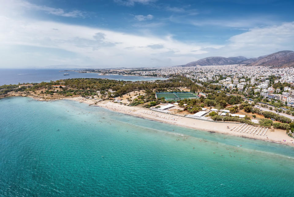 A beach with a city in the backdrop.