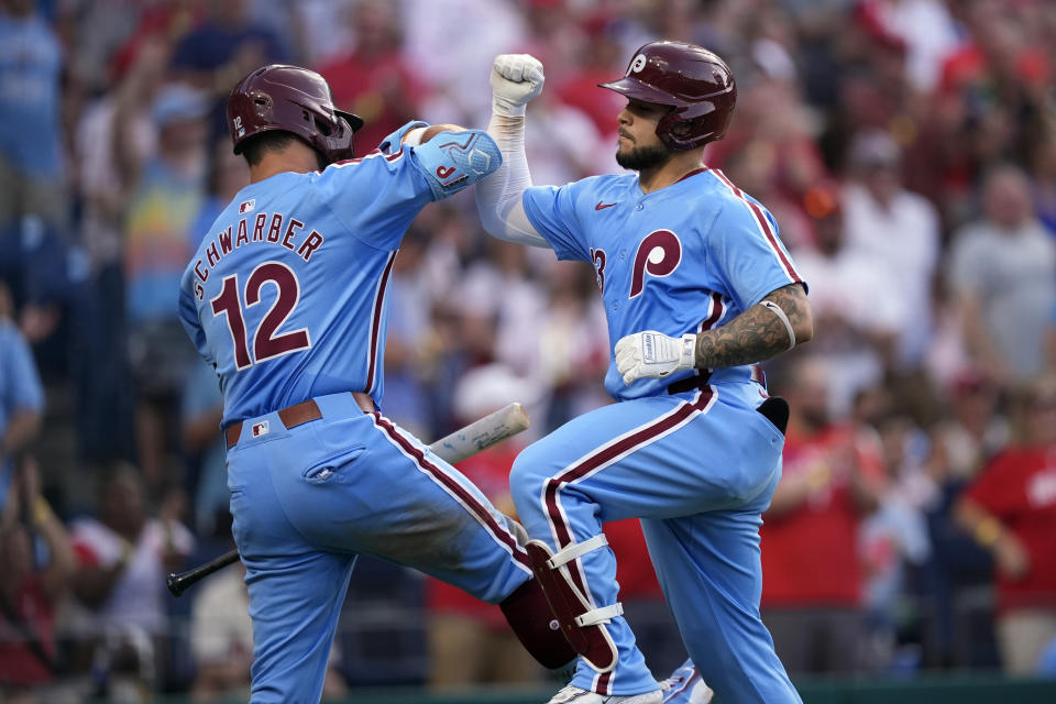 Philadelphia Phillies' Rafael Marchan, right, and Kyle Schwarber celebrate after Marchan's home run against Miami Marlins pitcher Trevor Rogers during the fourth inning of a baseball game, Thursday, June 27, 2024, in Philadelphia. (AP Photo/Matt Slocum)