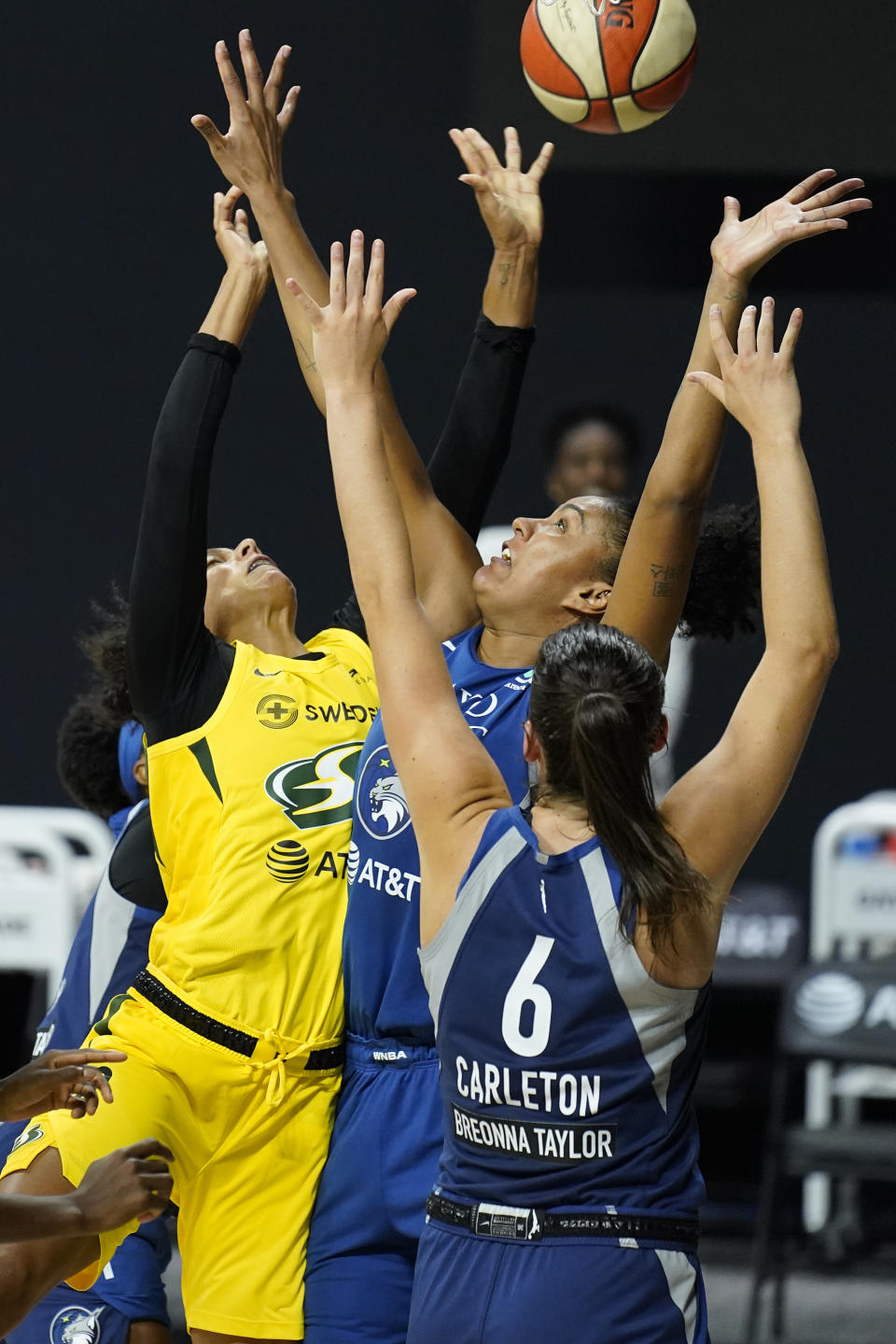 Seattle Storm forward Alysha Clark, left, puts up what proved to be the game-winning shot over Minnesota Lynx forward Napheesa Collier and guard Bridget Carleton during the second half of Game 1 of a WNBA basketball semifinal round playoff series Tuesday, Sept. 22, 2020, in Bradenton, Fla. (AP Photo/Chris O'Meara)