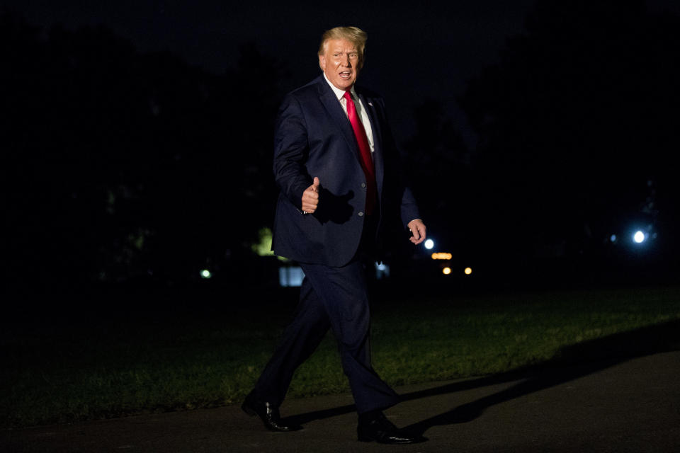 President Donald Trump gives a thumbs-up to members of the media as he walks across the South Lawn as he arrives at the White House in Washington, Sunday, Aug. 9, 2020, after returning from Morristown, N.J. (AP Photo/Andrew Harnik)