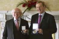 President Michael D. Higgins (L) poses as Irish Prime Minister Enda Kenny holds the holds the Seal of Taoiseach and the Seal of Government to office, in Dublin, Ireland May 6, 2016. REUTERS/Clodagh Kilcoyne