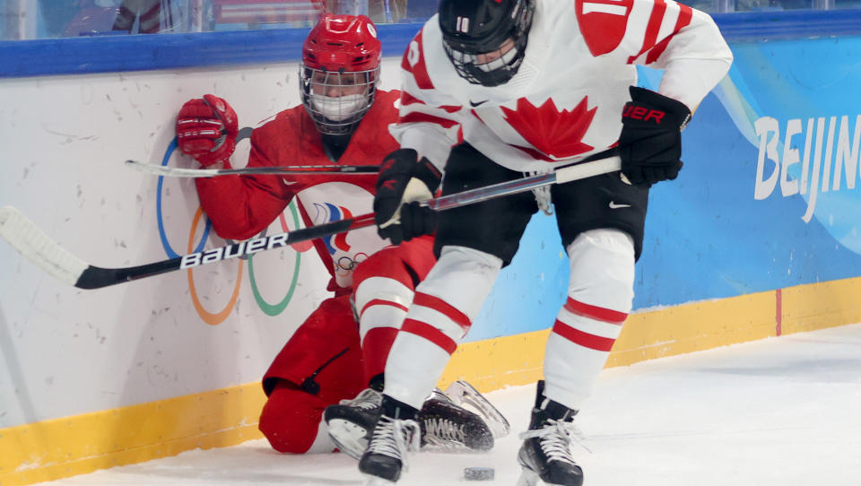 Russia's Polina Bolgareva battles for the puck with Canada's Sarah Fillier in their women's Group A ice hockey match at the 2022 Winter Olympic Games in Beijing. (Photo by Anton Novoderezhkin\TASS via Getty Images)