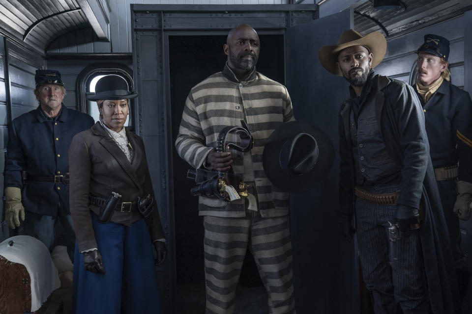 This image released by Netflix shows, foreground from left, Regina King, Isris Elba and Lakeith Stanfield from the film "The Harder They Fall." (David Lee/Netflix via AP)