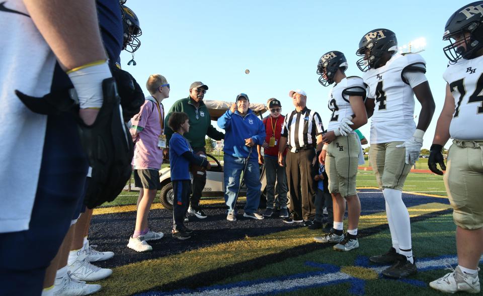 Gary Mervis, founder of Camp Good Days, handles the ceremonial coin toss during the Victor vs Rush-Henrietta Section V season opener. The matchup was the annual Teddi Bowl, a game played each season to celebrate and assist his organization, which helps families impacted by cancer and sickle cell anemia. Mervis' daughter Elizabeth "Teddi" Mervis died of cancer in 1982.