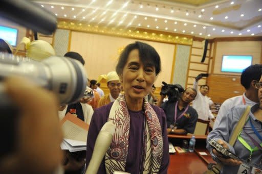 Aung San Suu Kyi speaks to media after taking her parliamentary oath in Naypyidaw on Wednesday. The 66-year-old stood to read the brief oath in unison with 33 other members of her National League for Democracy party elected to the lower house in April