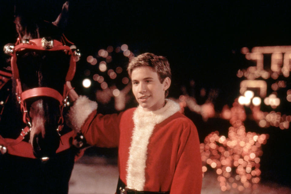 JTT in a santa suit and petting a horse