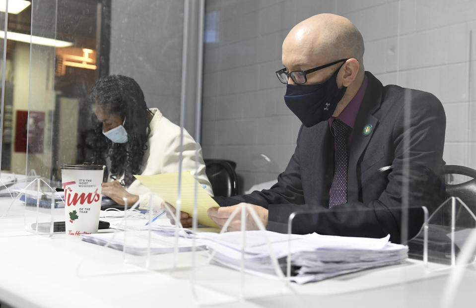 Wayne County Director of Elections Director Greg Mahar, right, gives the elections report to the Wayne County Board of Canvassers as Wayne County corporation counsel Janet Anderson-Davis, left, listens during a board meeting in Detroit on Tuesday, Nov. 17, 2020. On Thursday, Nov. 19, 2020, state officials said Wayne County, Michigan's largest county, cannot revoke its certification of election results after two Republicans who approved Democratic candidate Joe Biden's local landslide wanted to revert to their initial stance of refusing to bless the vote tally. State officials said the certification of the Detroit-area vote will stand. (Robin Buckson/Detroit News via AP)