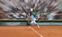 FILE - This May 13, 2014, file photo shows Serbia's Novak Djokovic as he returns the ball during a third round match of the French Open tennis tournament against Croatia's Marin Cilic at Roland Garros stadium in Paris. (AP Photo/David Vincent, File)