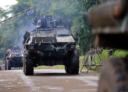 Armoured Personnel Carrier (APC) drives out at a military camp to reinforce government soldiers on their continuous assault with insurgents from the so-called Maute group, who has taken over large parts of the city, in Marawi, Philippines May 26, 2017. REUTERS/Romeo Ranoco