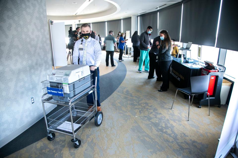 People receive the Pfizer-BioNTech COVID-19 vaccine at the University of Iowa Stead Family Children's Hospital in Iowa City on Dec. 14, 2020.