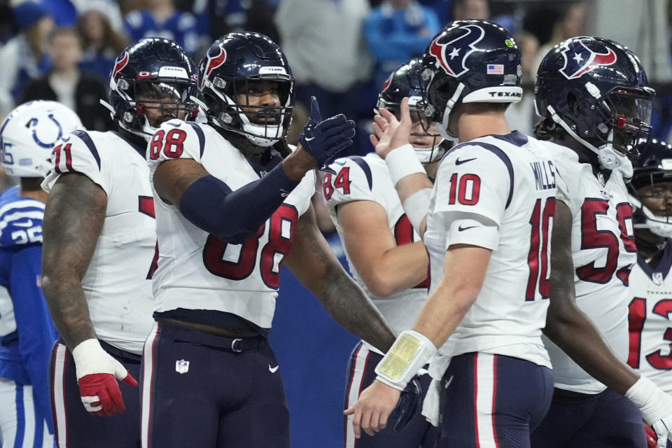 Houston Texans tight end Jordan Akins (88) is congratulated by Houston Texans quarterback Davis Mills (10) after scoring a two-point conversion during the second half of an NFL football game between the Houston Texans and Indianapolis Colts, Sunday, Jan. 8, 2023, in Indianapolis. (AP Photo/AJ Mast)