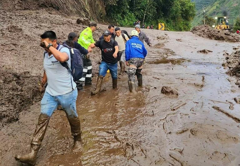 Image publiée par la police équatorienne montrant des policiers en train d'aider des civils à évacuer le site d'un glissement de terrain à Baños, en Équateur, le 16 juin 2024 (Policía de Ecuador)