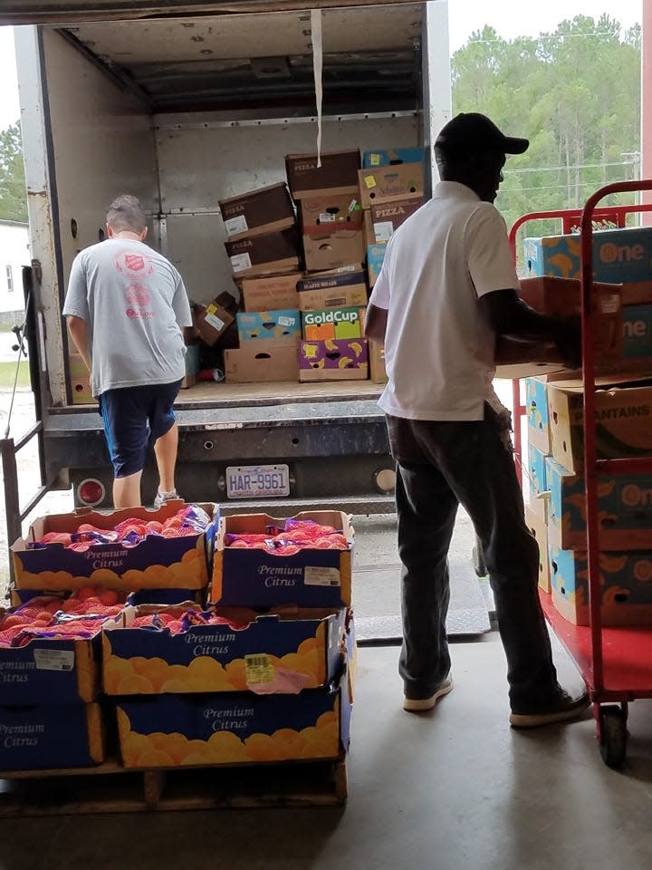 Salvation Army employees unload a truck with food for the Jacksonville center food pantry. The items were packed into food boxes for local residents as they prepared for Hurricane Dorian in 2019.