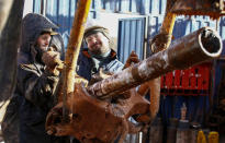 Drilling crew members raise a drill pipe onto a drilling rig floor at the Yarakta Oil Field, owned by Irkutsk Oil Company (INK), in Irkutsk Region, Russia March 11, 2019. REUTERS/Vasily Fedosenko