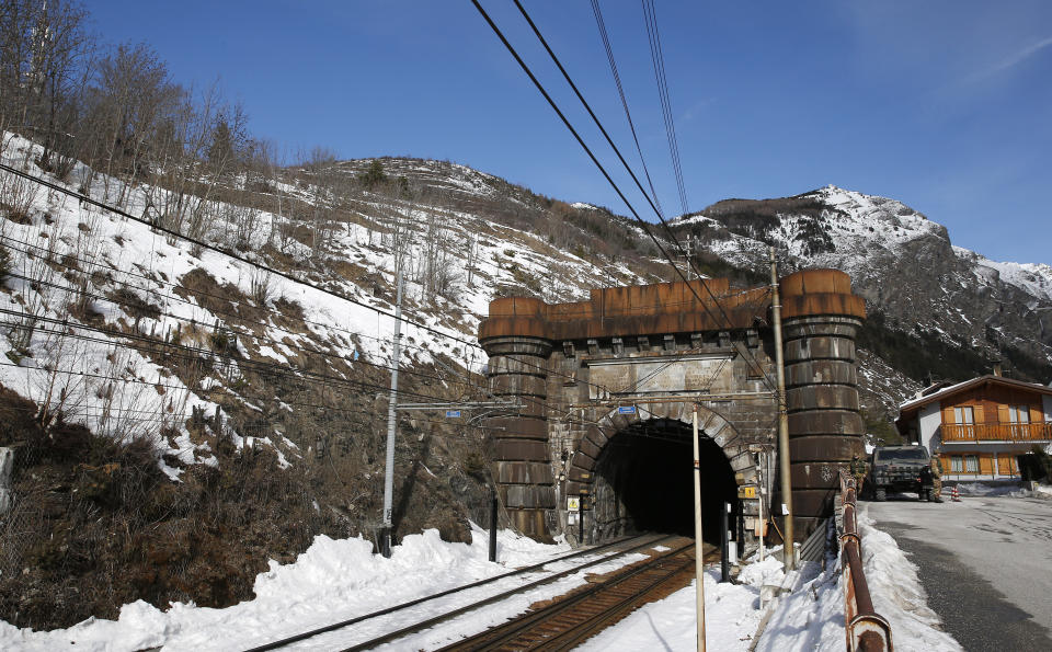 A view of the Italian entrance of the 1871 Frejus tunnel on the conventional railway between Italy and France in Bardonecchia, Italy, Tuesday, Feb. 12, 2019. This tunnel would be substituted by a Turin-Lyon high-speed railway tunnel system that is part of a European wide network to improve high-speed rail connections. On the Italian side, the construction site long targeted by sabotaging protesters is guarded by four law enforcement agencies and has been reduced to maintenance work only. The survival of Italy's increasingly uneasy populist government could very well depend on whether Italy restarts construction on the TAV link, which it halted in June. (AP Photo/Antonio Calanni)