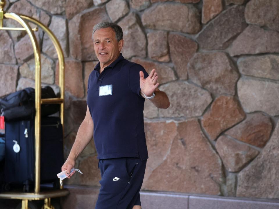 Disney chairman Bob Iger waves while walking by entry of Sun Valley conference