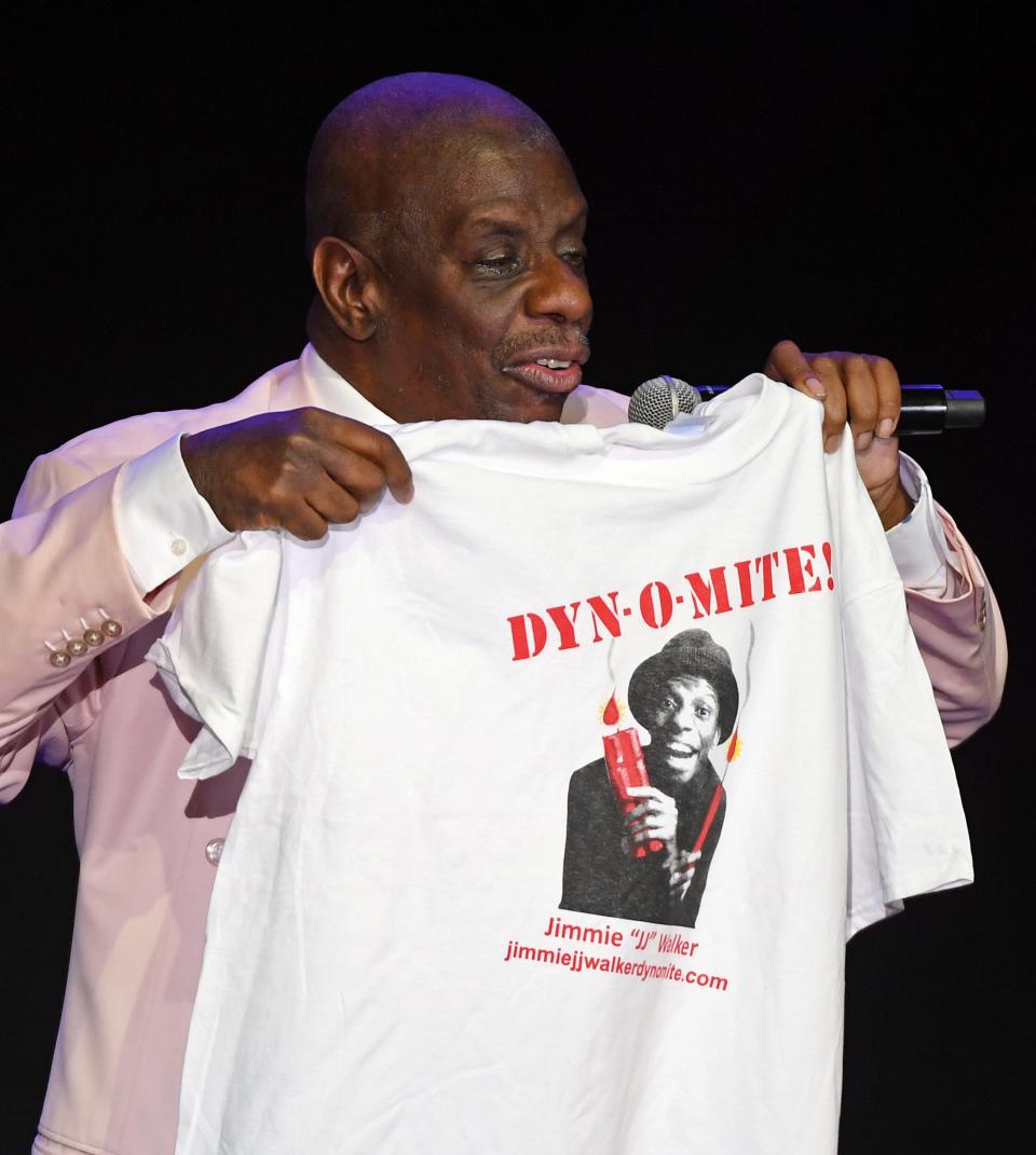 Actor/comedian and host Jimmie Walker holds up a T-Shirt with his catchphrase "Dy-no-mite!" from the television show 'Good Times' as he performs his stand-up comedy routine before introducing Deon Cole at The Orleans Showroom at The Orleans Hotel & Casino on Aug. 24, 2019 in Las Vegas, Nevada.