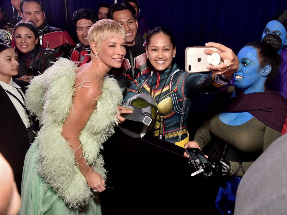 Evangeline Lilly poses with fans for a selfie during the Ant-Man and The Wasp Quantumania world premiere at Regency Village Theatre in Westwood, California on February 06, 2023.